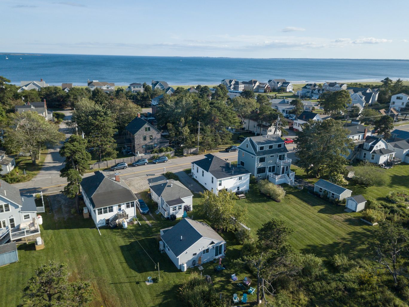 Aerial view of a coastal neighborhood with the ocean beyond.