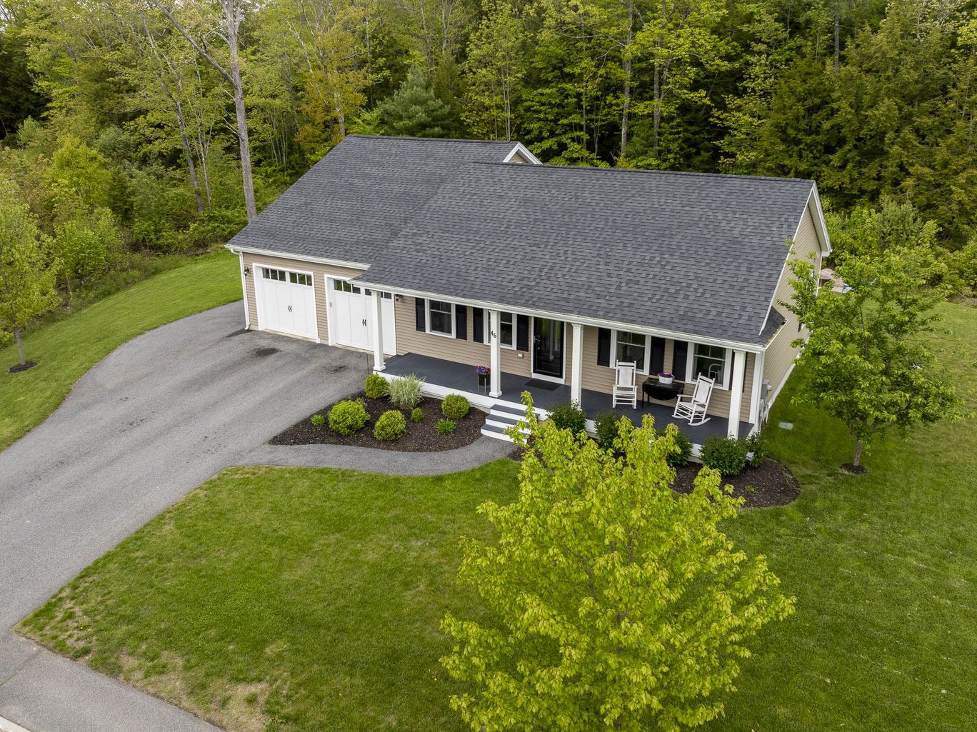 Low aerial view of a single storey home in afternoon light.